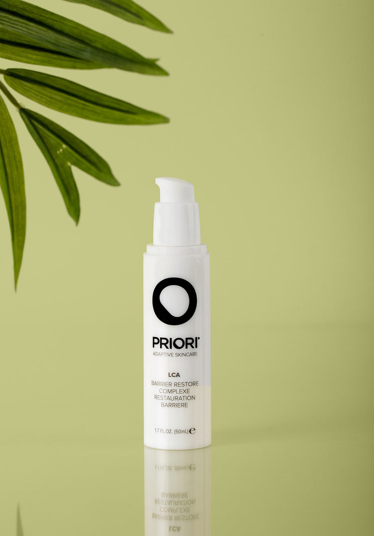 PRIORI LCA Barrier Restore Complexe Soothing Moisturizer with Ceramides. TSA compliant white skincare bottle on a green background.
