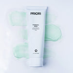 A white squeeze tube of PRIORI Hydrofill Mask centered on a white background with soft mint-green gel swatches behind it.