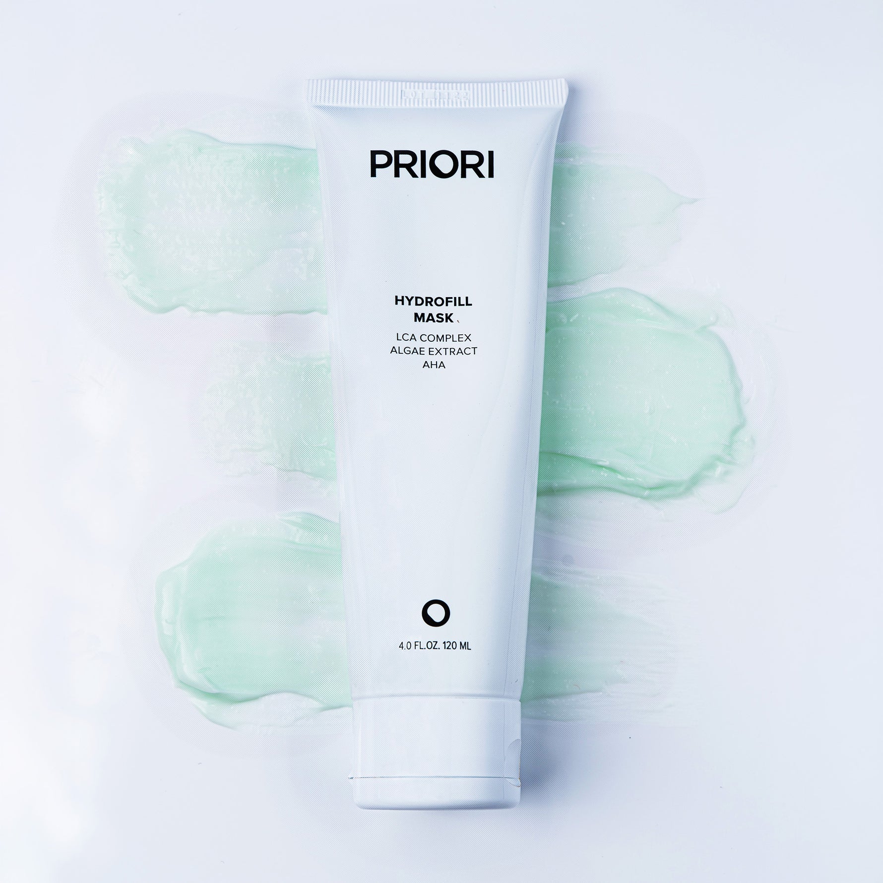 A white squeeze tube of PRIORI Hydrofill Mask centered on a white background with soft mint-green gel swatches behind it.