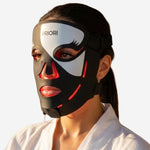 PRIORI Face Red Light Therapy Mask in Black and White FDA Cleared Anti-aging closeup on model.