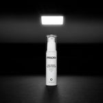 Priori Age Renew Glow Serum Anti aging cream with retinol, Vitamin C, and AHA with packaging on a black background.