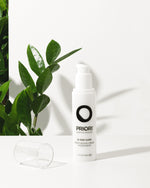 PRIORI Skincare Q+ SOD Moisturizing Cream with Retinol, CoQ10, LCA Complex Bottle with Plant in the Background