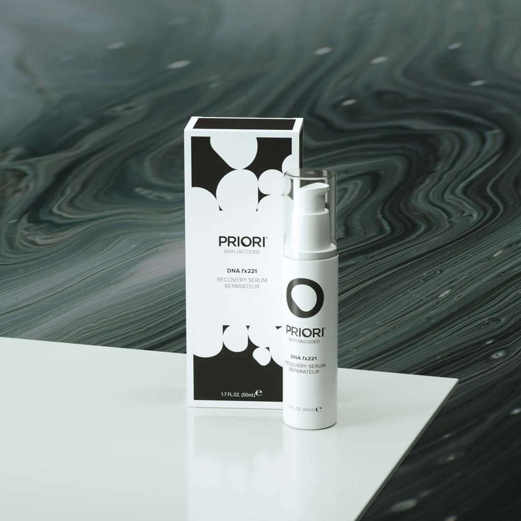PRIORI DNA Recovery Face Serum Product and Packaging on white counter with black background